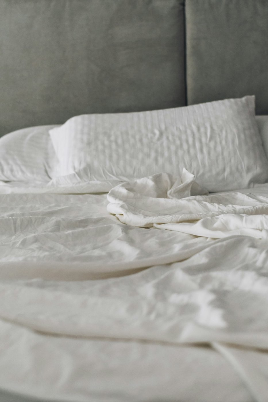 Guest bed dressed in white linen