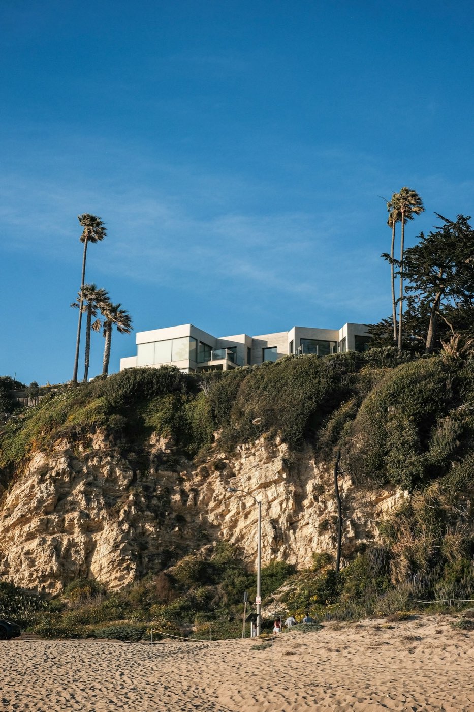 Modern house on a coastal bluff above the beach