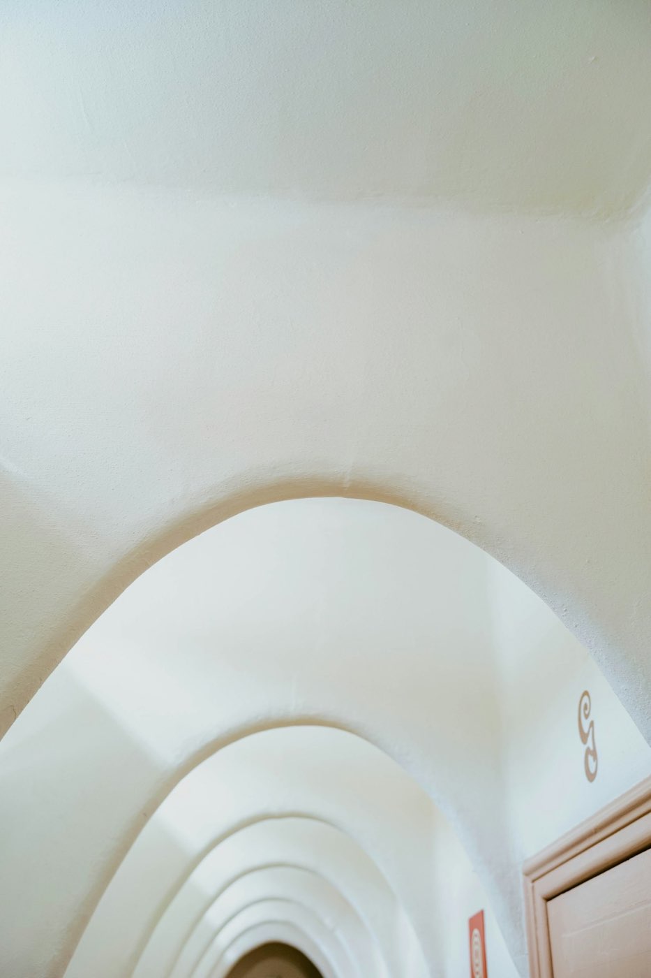 Arched plaster hallway in soft white