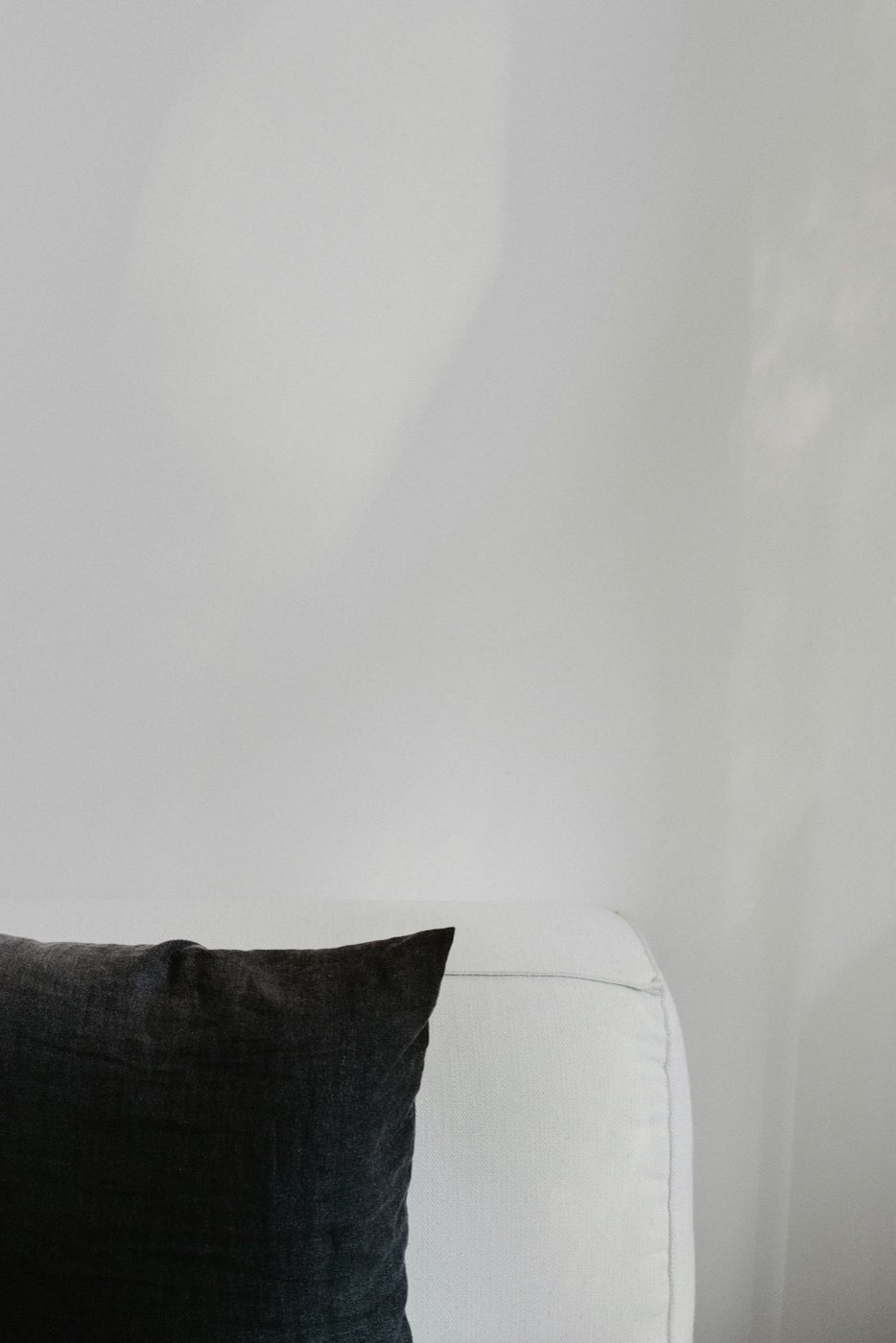 Detail of layered grey and cream throw pillows